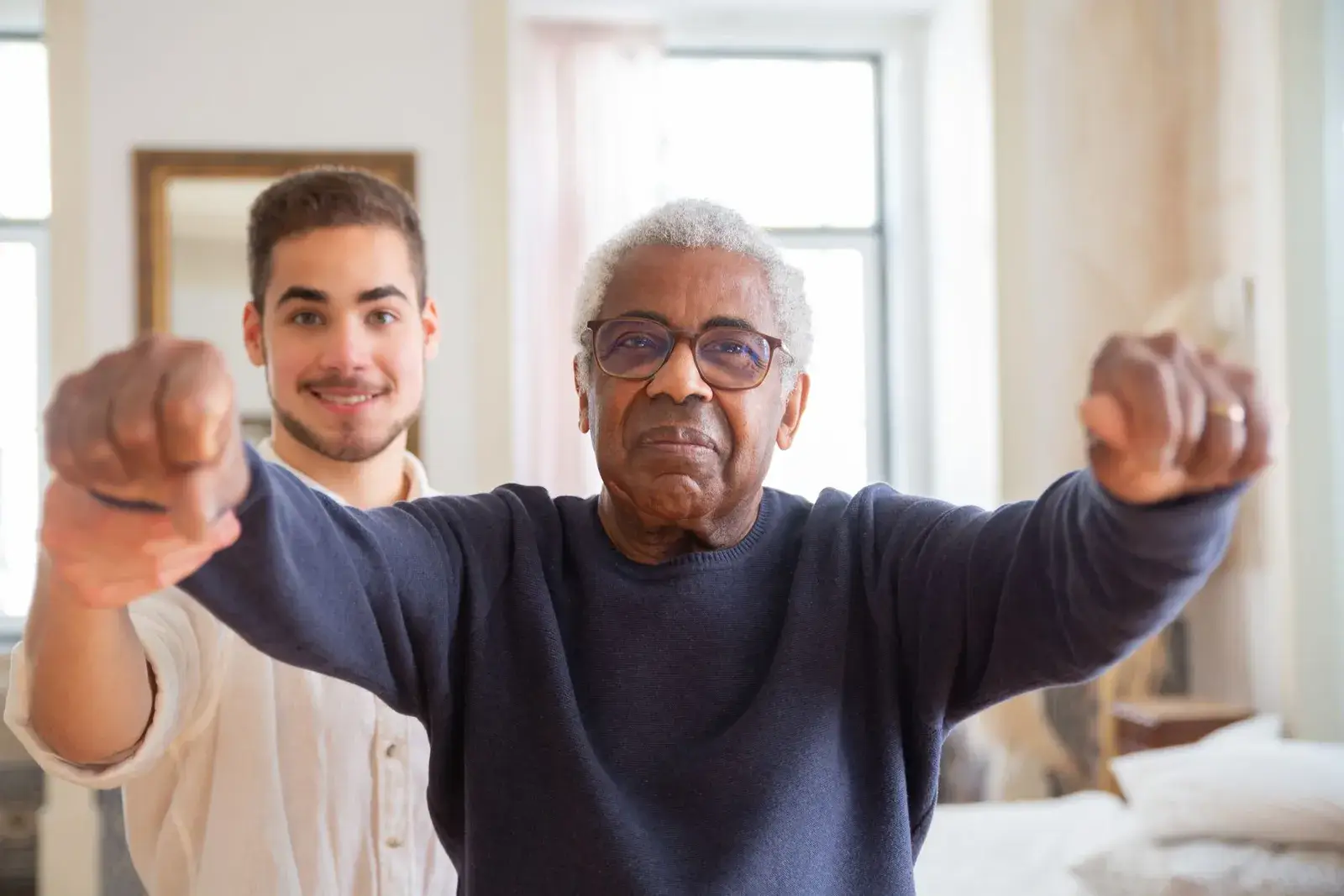 A clinician guiding an older patient through a movement and range-of-motion assessment